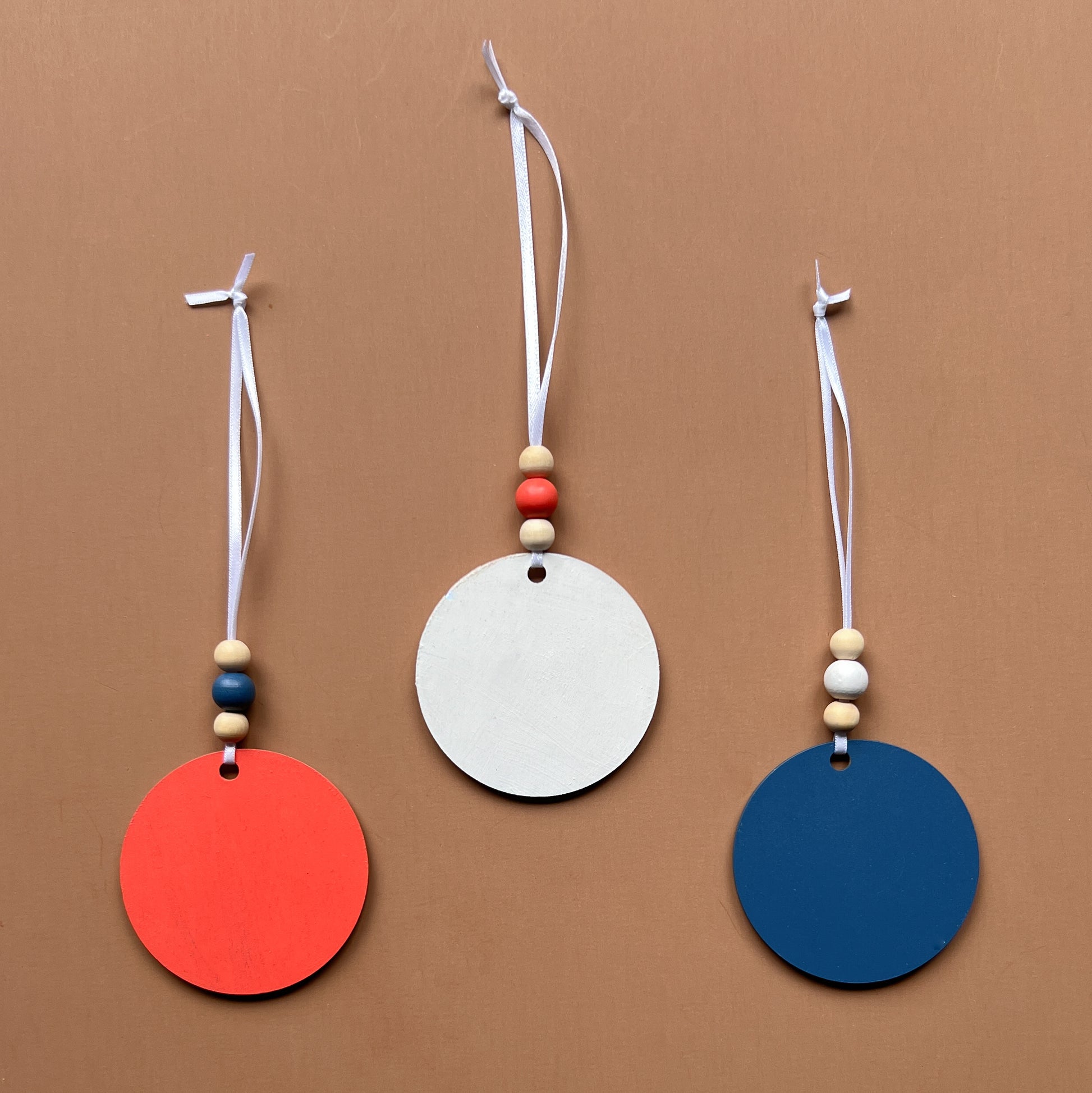 At the Seashore Beachy Set. Three wood ornaments featuring a shell, the sun, or a crab. Summer decor, year-round holiday tree ornament, or gift.