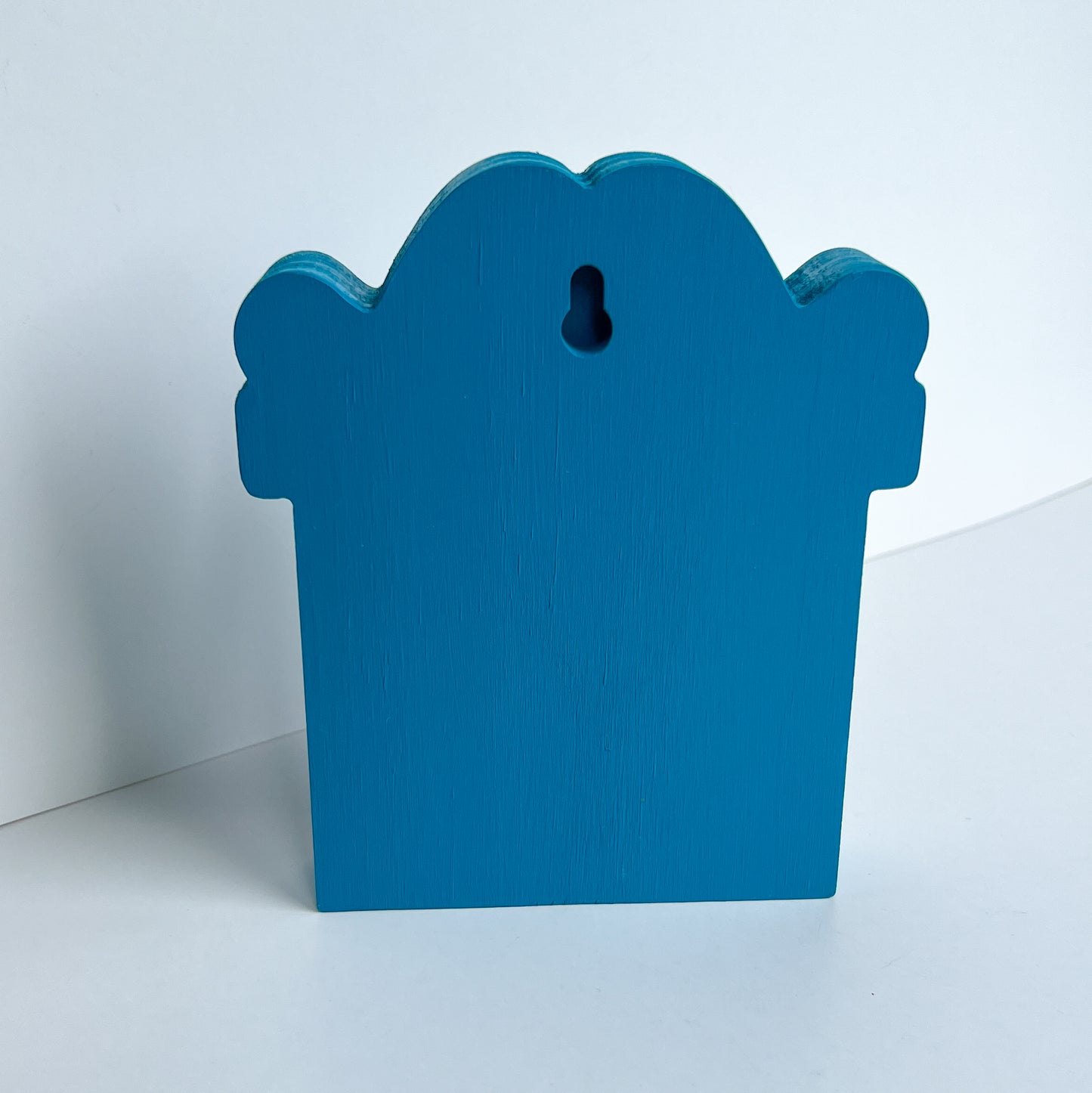 Bright Boo Tombstone Shelf Sitter. Features vibrant colors of blue and purple with a ‘boo’ wood cutout and a little skull. It's free standing, but has a keyhole cutout on the back so can hang on the wall. Halloween decor.