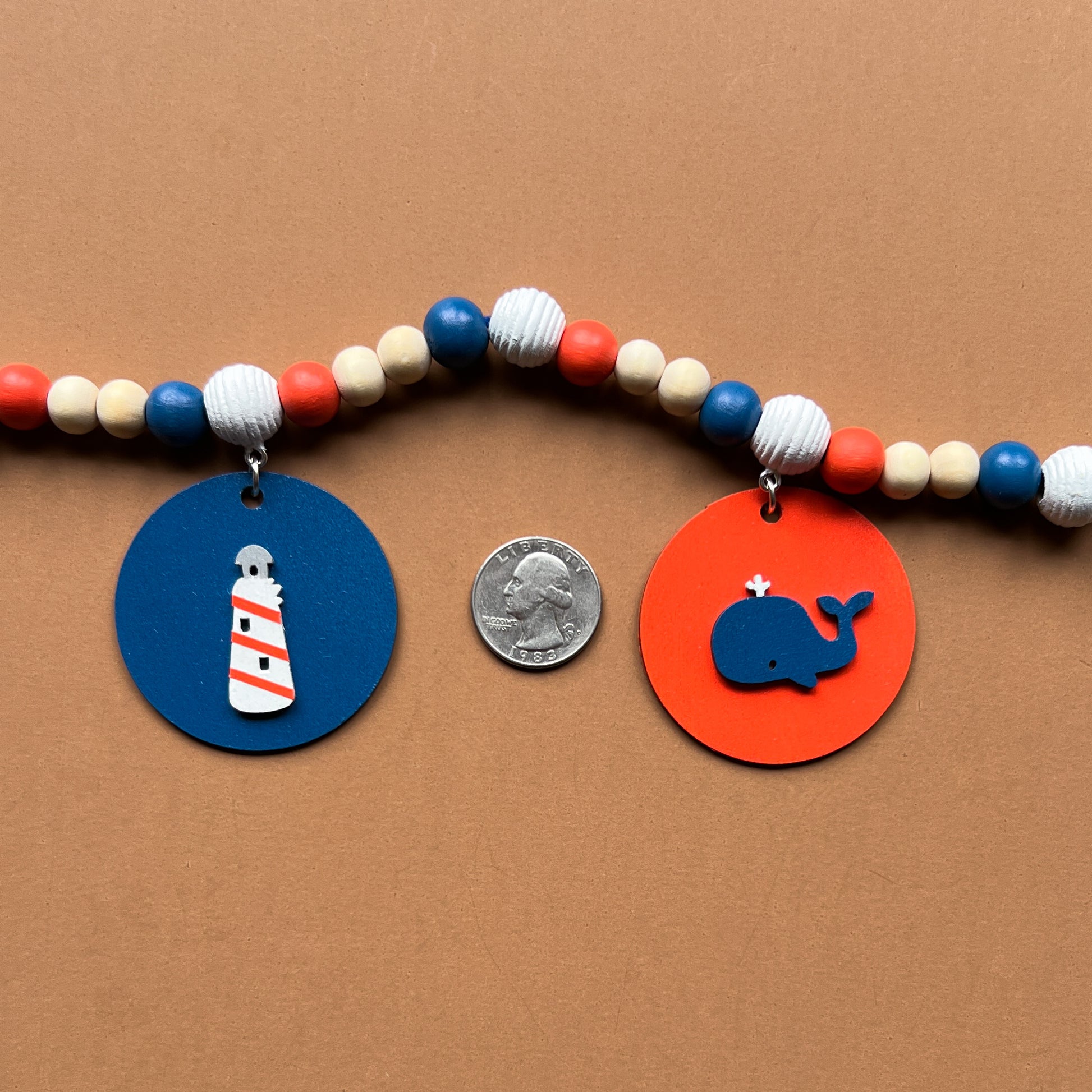 Calm Little Seas Handmade Mini Garland. Features wood circles with a fish, sailboat, anchor, lighthouse, whale. Summer nautical beachy decor or gfits.