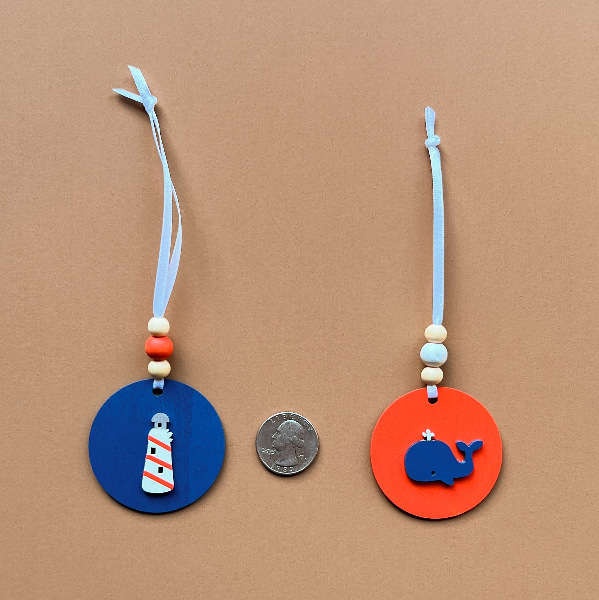 Calm Little Seas Handmade Ornament Set of 5. Ornaments feature ocean themed shapes – a fish, a sailboat, a ship anchor, a lighthouse, and a whale.  Summer seasonal decor; year-round tree ornaments or gifts.