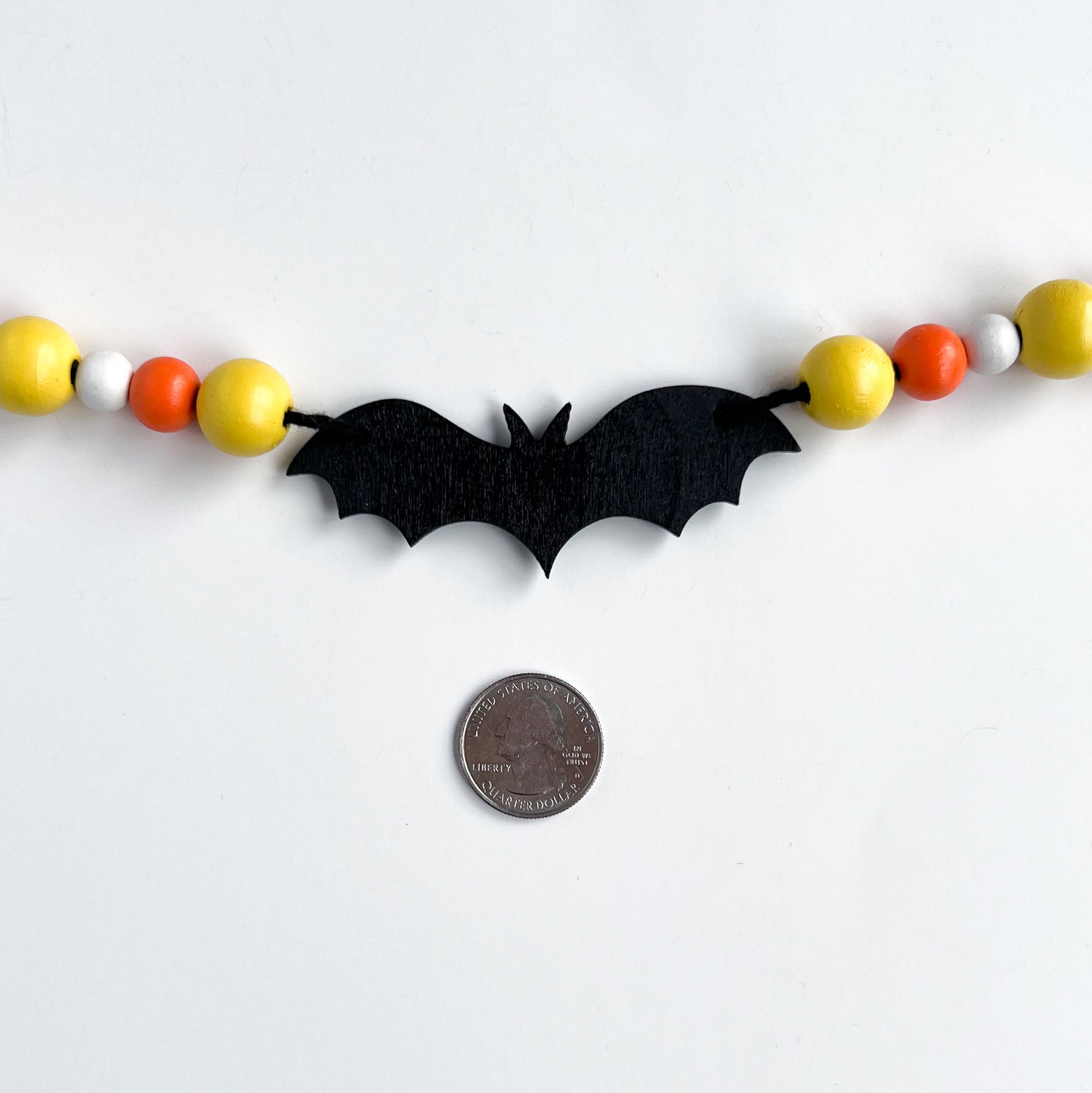 Candy Bats Handmade Garland. The garland features three black bats strung with wood beads in candy corn colors. Halloween, autumn, fall theme decoration or gift.
