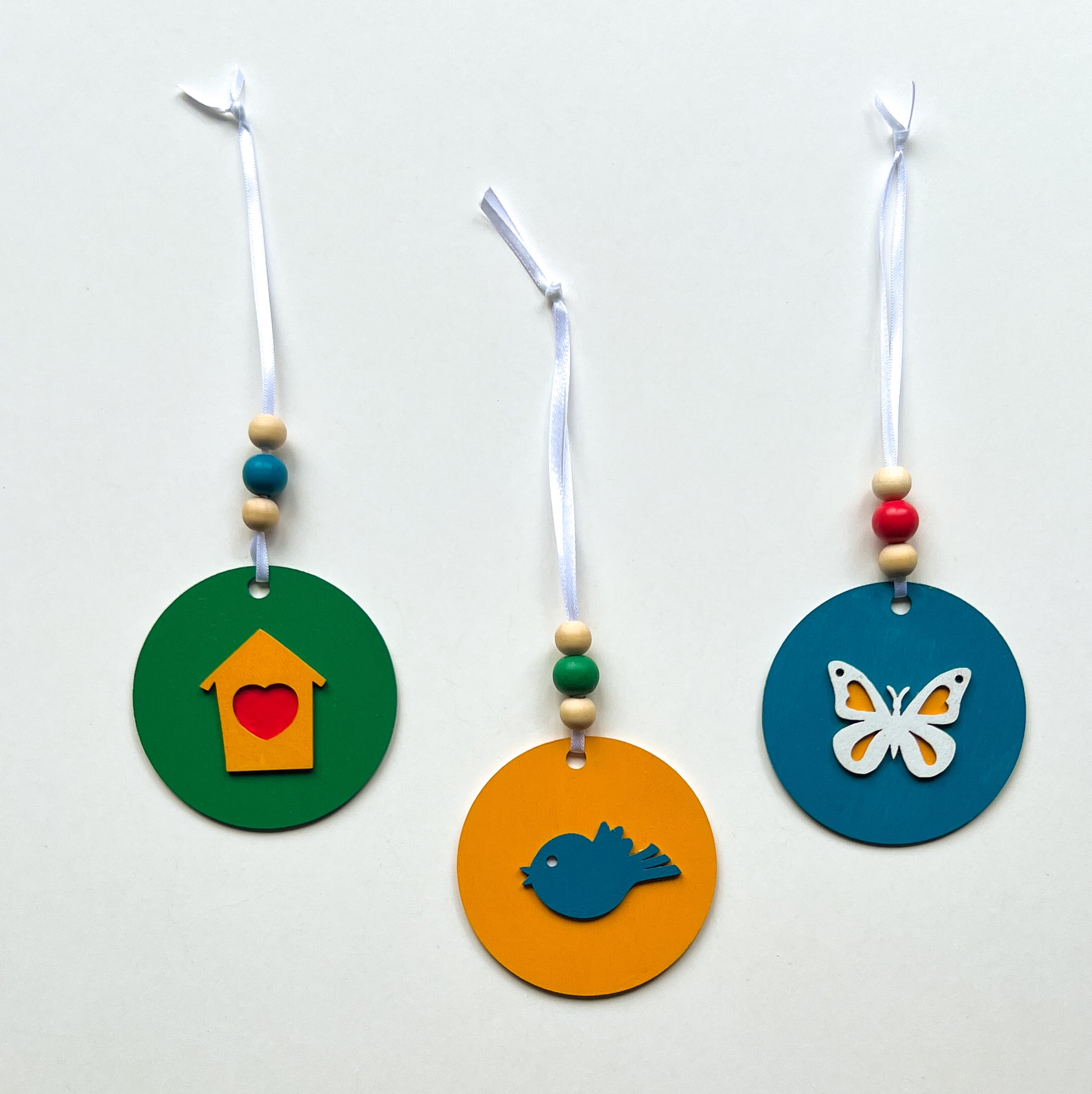 In the Garden Ornament Set. Three ornaments featuring a bird, birdhouse, butterfly. Year-round holiday tree, spring decor or gift.