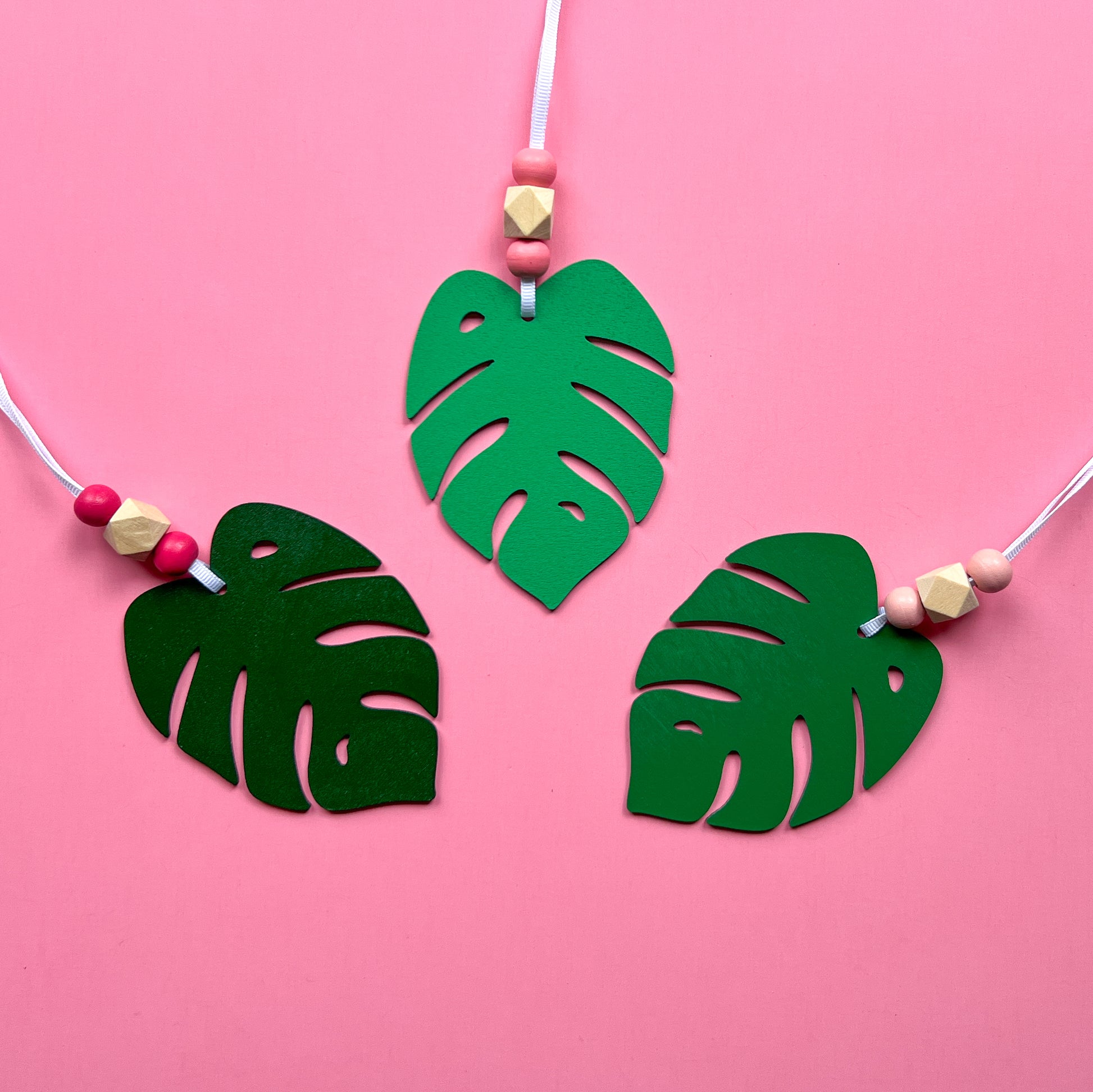 Tropical Breeze Handmade Ornament Set of 3. Wood monstera leaf ornaments with wood beads. Summer, tropical themed home decor and gifts.