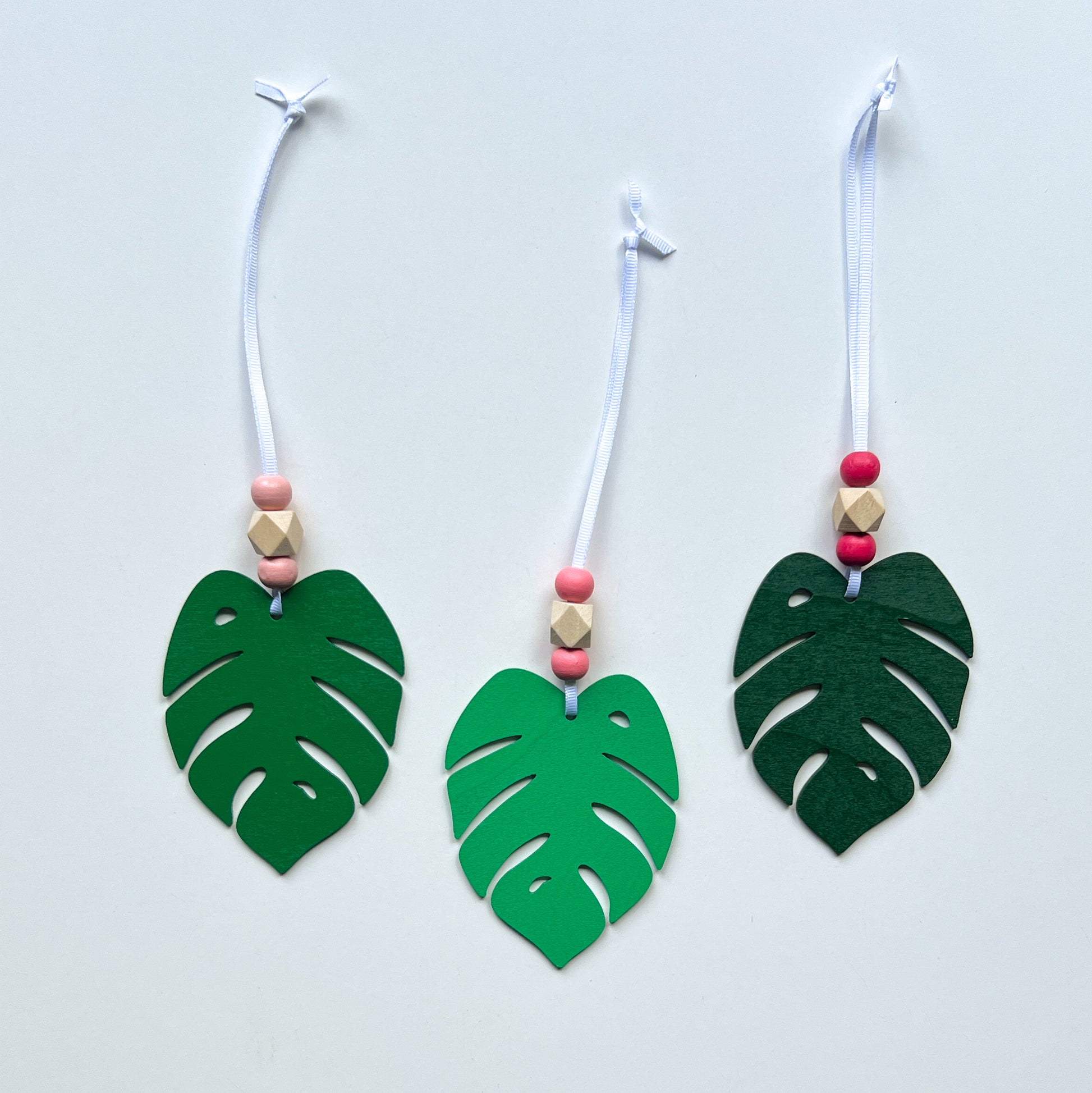 Tropical Breeze Handmade Ornament Set of 3. Wood monstera leaf ornaments with wood beads. Summer, tropical themed home decor and gifts.