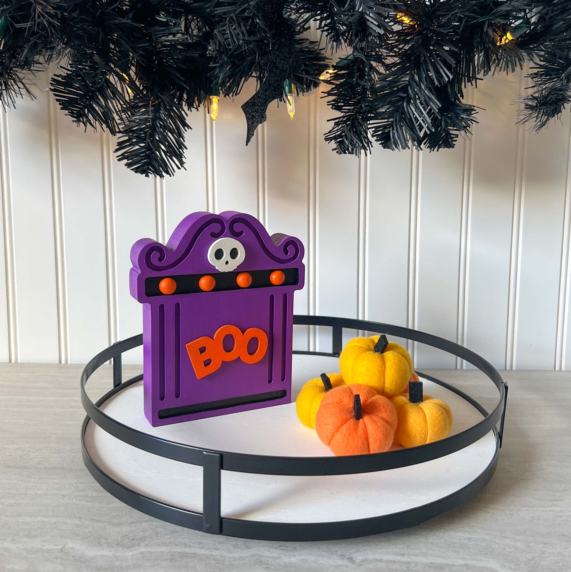 Bright Boo Tombstone Shelf Sitter. Features vibrant colors of purple and orange with a ‘boo’ wood cutout and a little skull. It is free standing, but has a keyhole cutout on the back so can hang on the wall. Halloween decor.