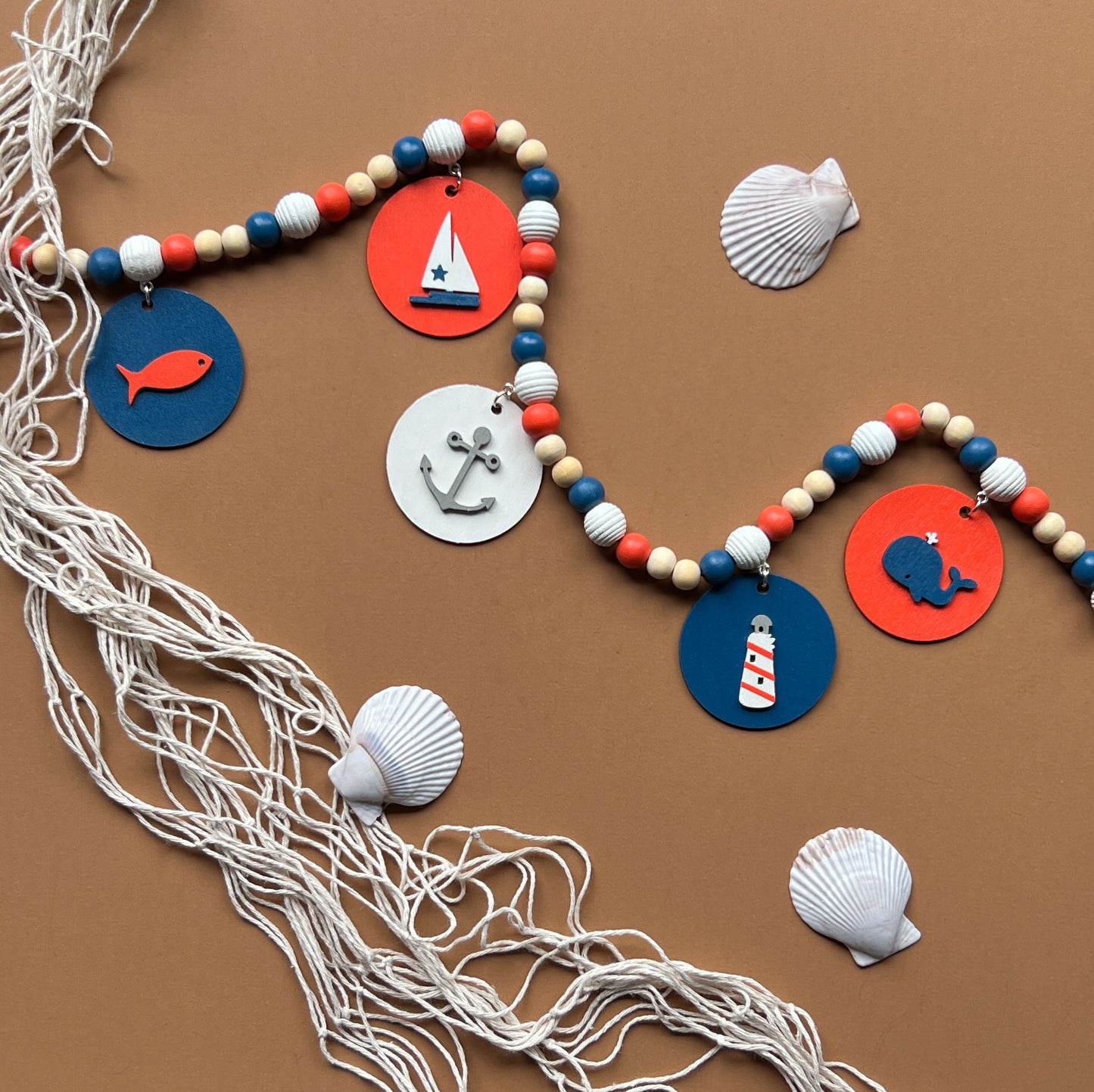 Calm Little Seas Handmade Mini Garland. Features wood circles with a fish, sailboat, anchor, lighthouse, whale. Summer nautical beachy decor or gfits.