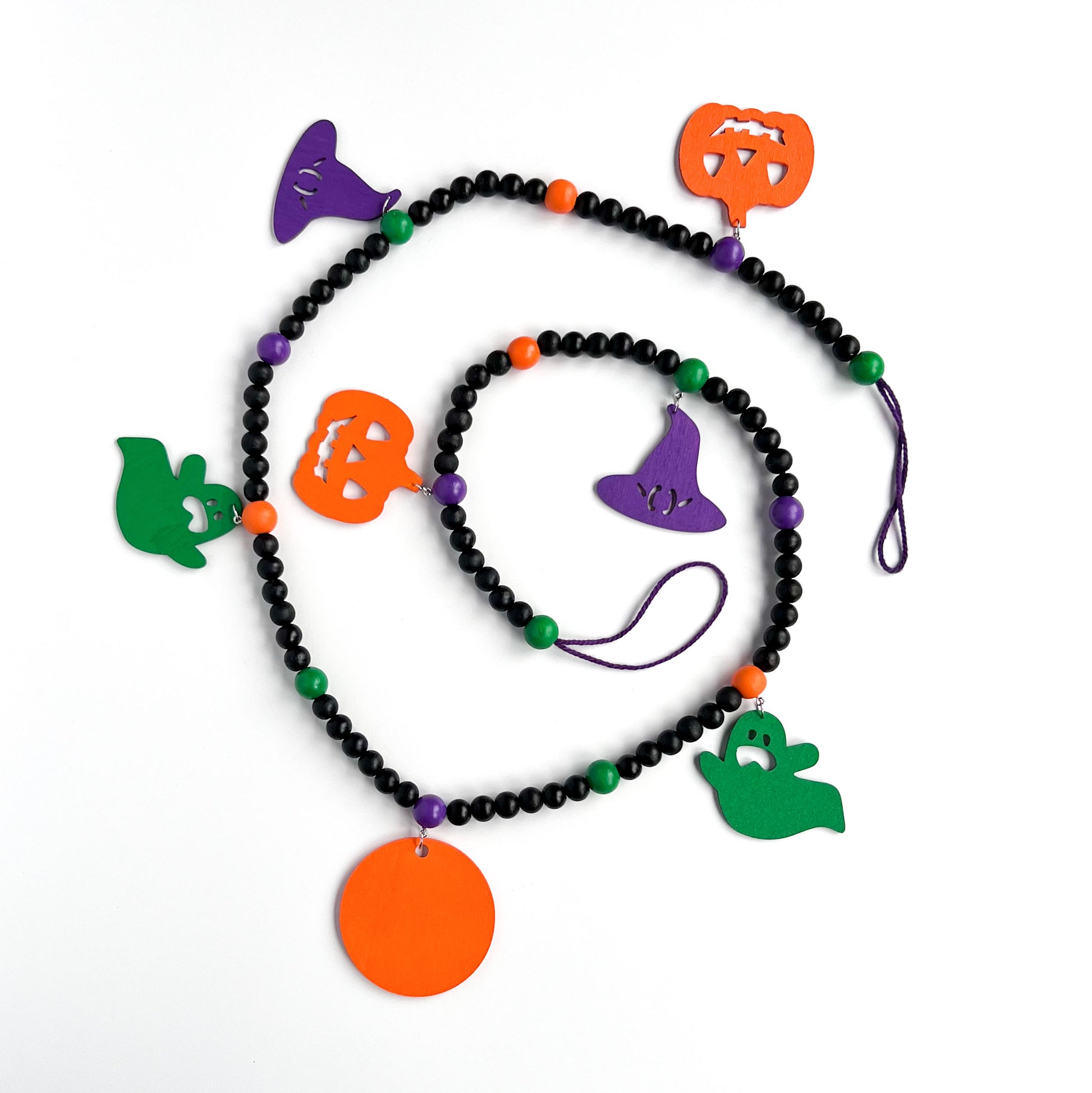 Eek! It’s Halloween Handmade Garland. The garland features seven Halloween themed shapes - pumpkins, ghosts, and witches’ hats. Shapes hang from painted wood beads. Halloween fall seasonal decoration or gift.