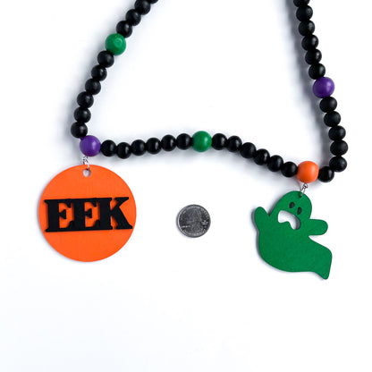 Eek! It’s Halloween Handmade Garland. The garland features seven Halloween themed shapes - pumpkins, ghosts, and witches’ hats. Shapes hang from painted wood beads. Halloween fall seasonal decoration or gift.
