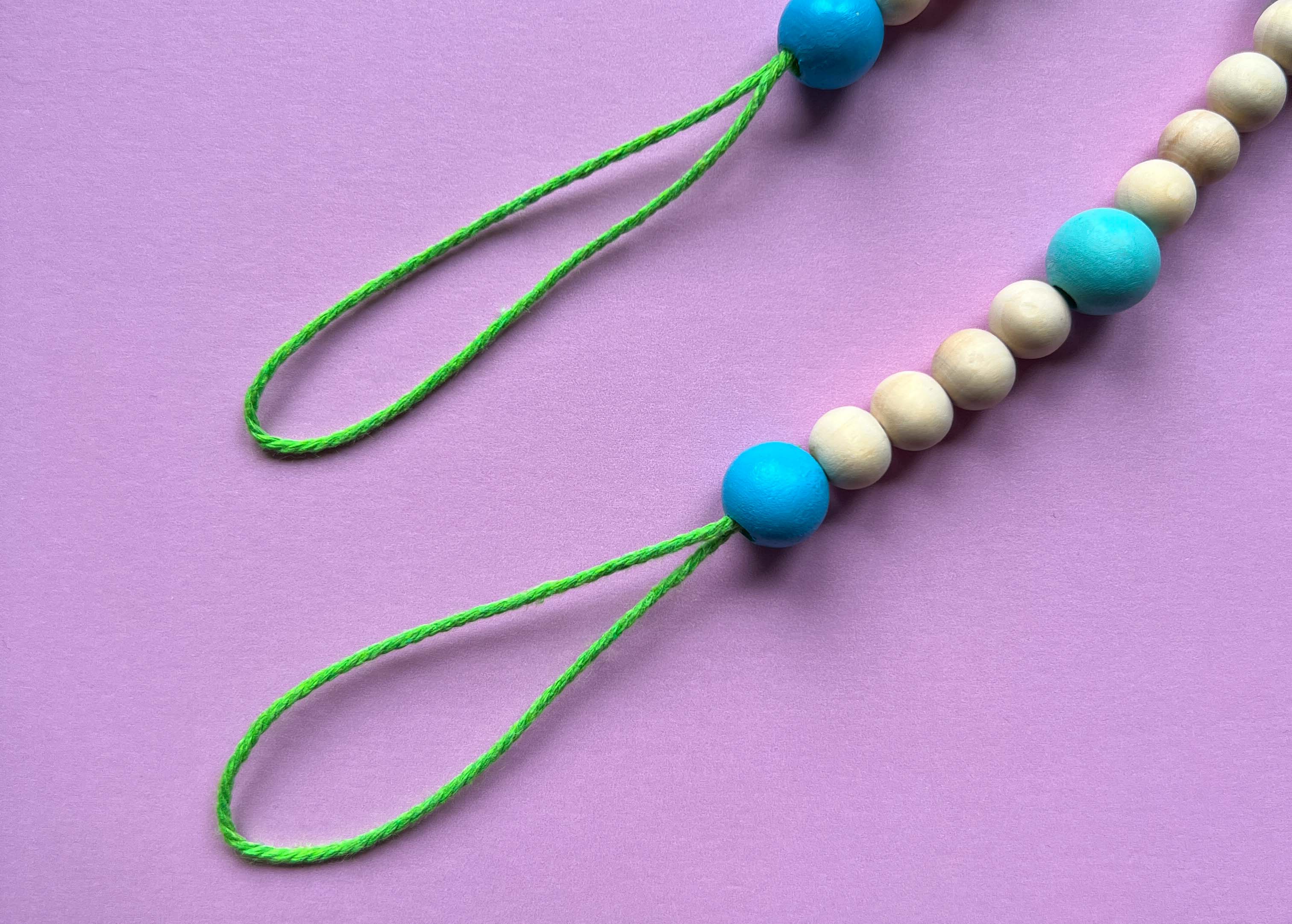 Image of end loops on a wood bead garland to hang the garland from.