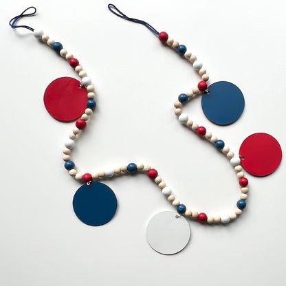 Happy 4th of July Handmade Garland. Features patriotic-themed shapes - a star, a "USA" and a 4th of July wood cutout, Uncle Sam's hat, and a firecracker. Summer red, white, blue decor and gifts.