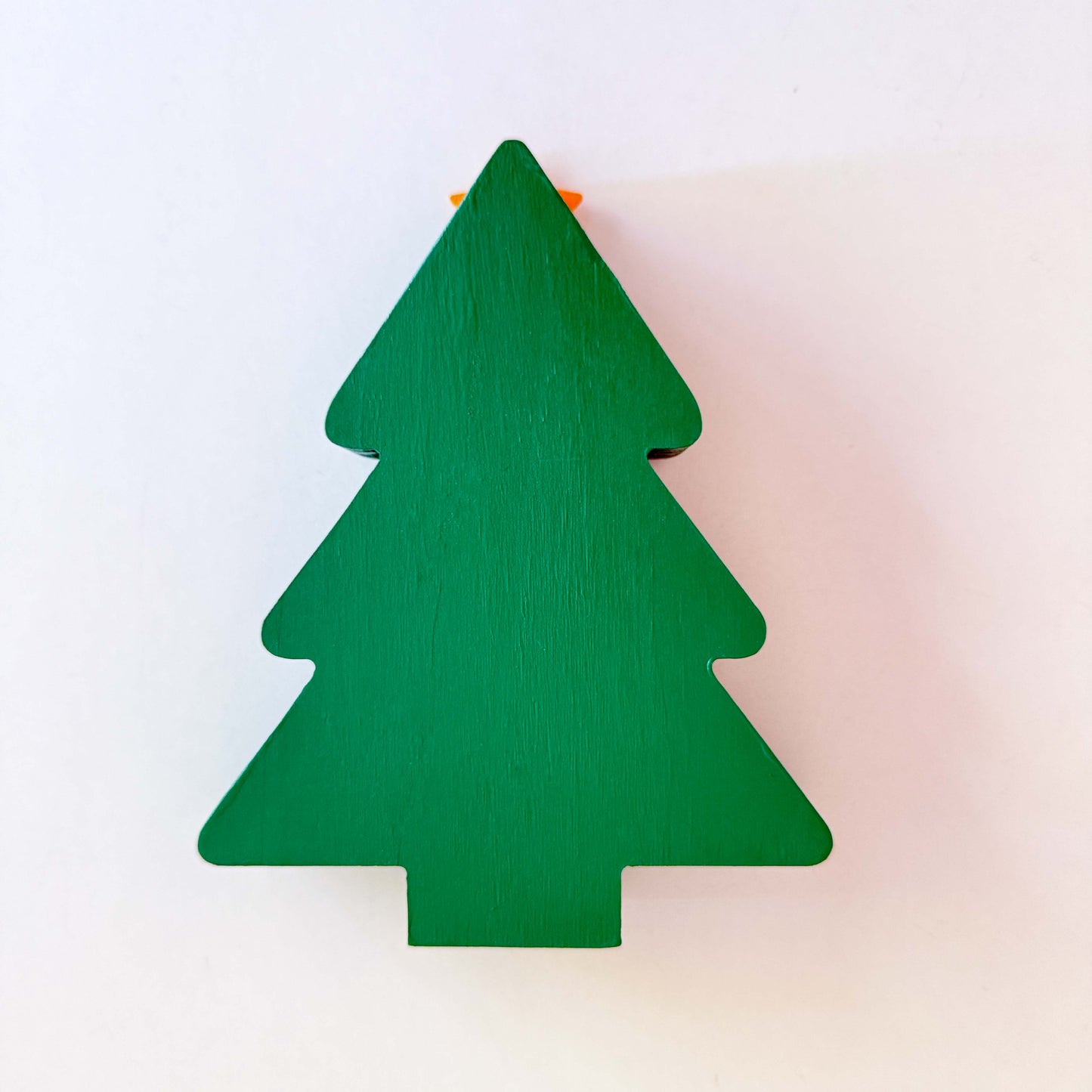 Back of wood Christmas tree shelf sitter painted green. 