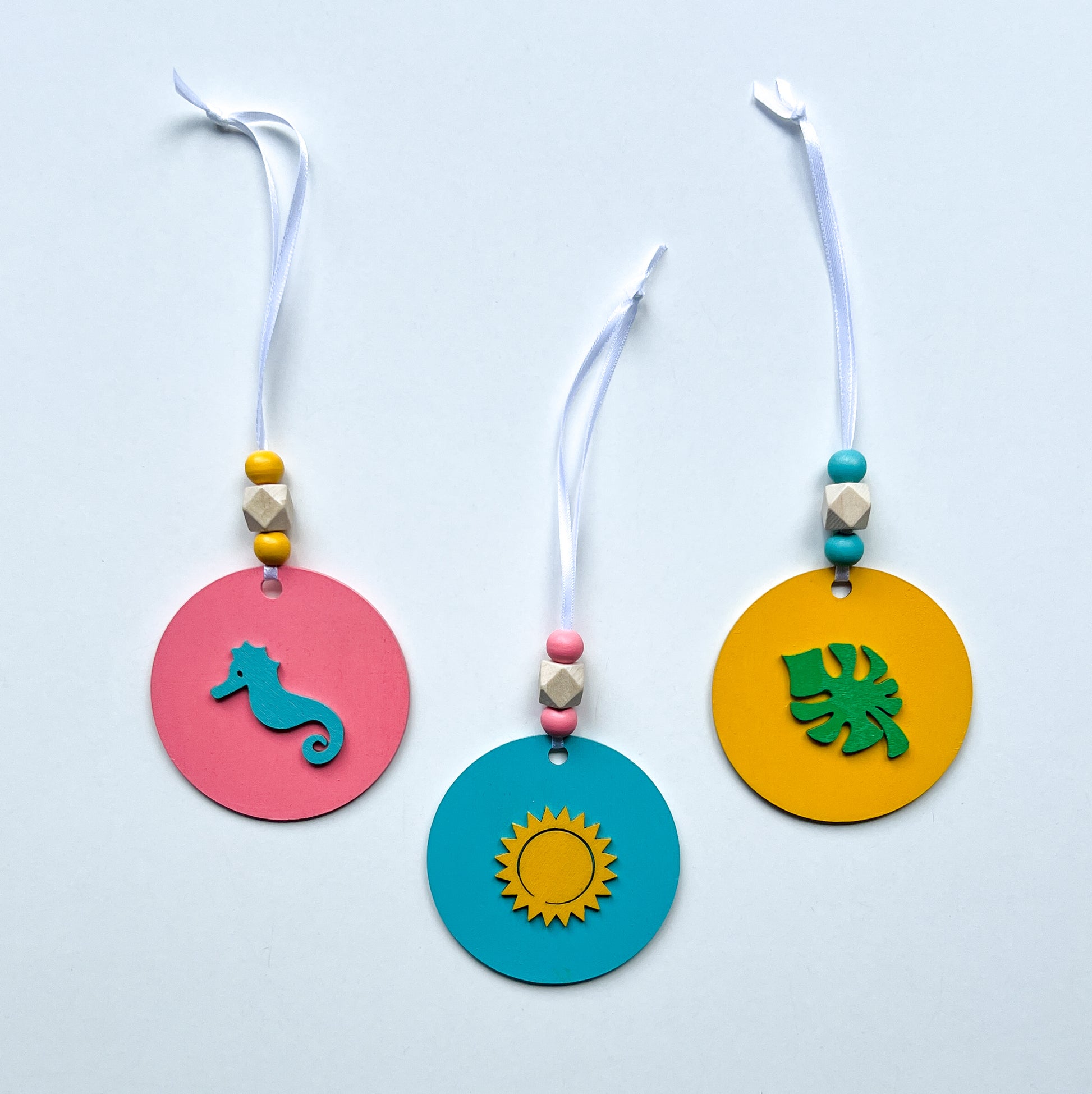 Summer Vacay Ornament Beach Set. Wood ornaments with a seahorse, monstera leaf, or sun. Summer tropical decor or gift; year-round holiday tree decoration.